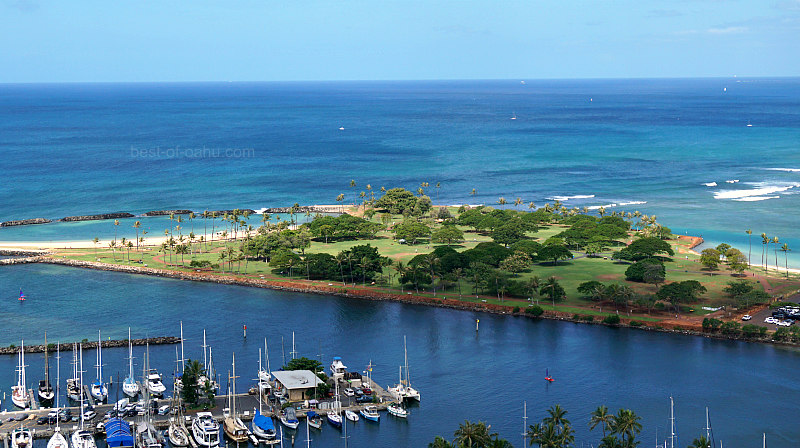 The Ala Moana Magic Island offers a stunning aerial view of a man-made peninsula in Honolulu, Hawaii, adjacent to Ala Moana Beach Park and the Ala Wai Yacht Harbor, providing a picturesque setting for recreational activities and relaxation.
