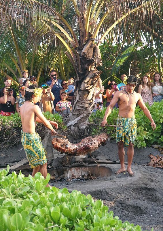 The Germaine's Luau Kalua Pig Imu features the traditional underground oven used to slow-cook and roast the succulent Kalua pig, a centerpiece of the luau feast at Germaine's Luau in Kapolei, Hawaii.