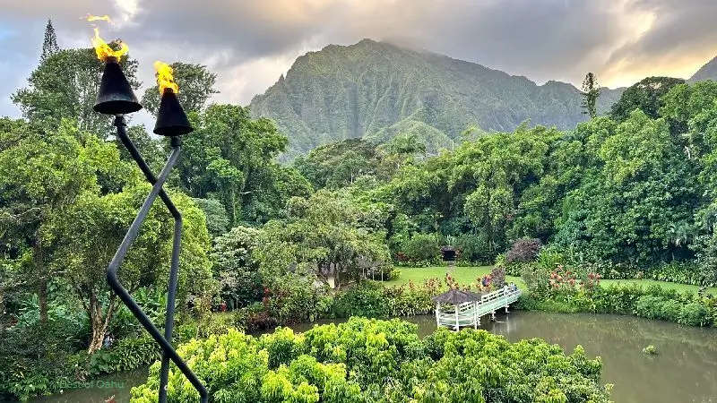 Haleiwa Joe's Haiku Gardens with a view of their koi pond & gazebo below, and also with beautiful botanical gardens surrounding the property, and the Ko'olau Mountains in the background.