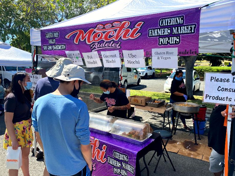 At the KCC Farmers Market, you can find delicious and unique mochi treats, including flavors like strawberry mochi, offered by various vendors. 🍡🍓 It's a must-try dessert option at the market!