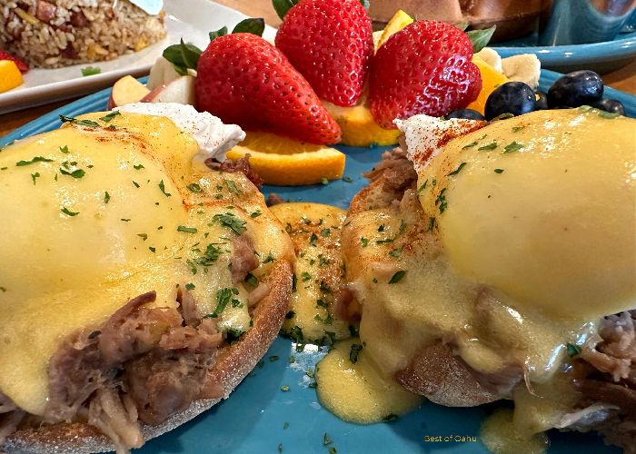 Kailas Oahu Breakfast plate with Kalua Pork eggs benedict and fresh fruit.