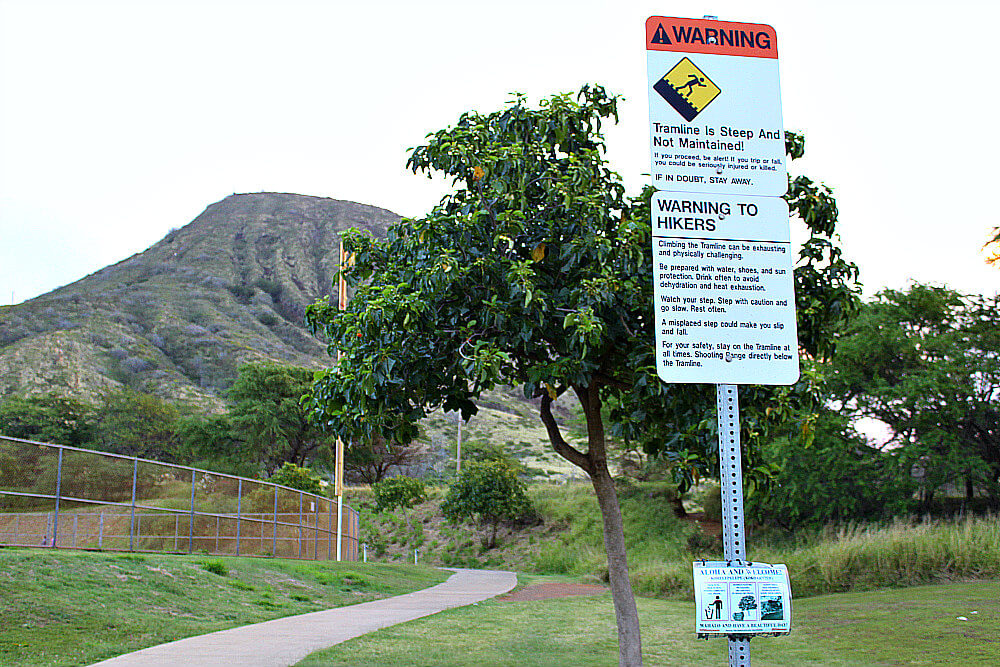 Koko Crater Trail Sign The Koko Crater Trail sign provides information about the trail's steep incline, reaching an elevation of 990ft, and the rewarding views at the summit of Koko Head Crater, which stands at 1208ft above sea level.