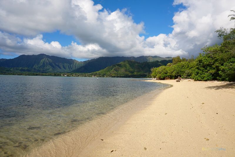 Kualoa Secret Beach Strip is a hidden gem on the island of Oahu, Hawaii, offering a secluded and picturesque stretch of sandy beach, turquoise waters, and breathtaking views of the surrounding mountains and coastline.