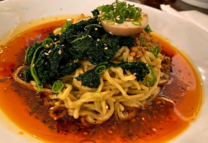 Momosan Spicy Dan Dan at Momosan Ramen is a tantalizing and fiery bowl of ramen that combines bold flavors, including spicy miso, ground pork, and a variety of aromatic spices, creating a mouthwatering and satisfying culinary experience.