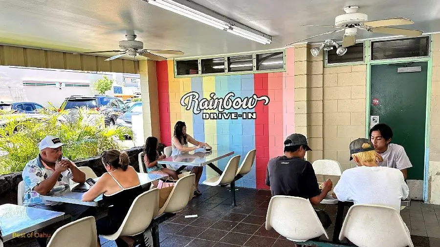 Rainbow Drive In Outdoor Dining Area with Rainbow logo on the wall.