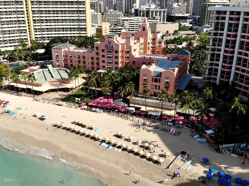 Royal Hawaiian Hotel Drone Photo above the Pacific Ocean capturing the Pink Palace Hotel and Waikiki Beach in front of it.