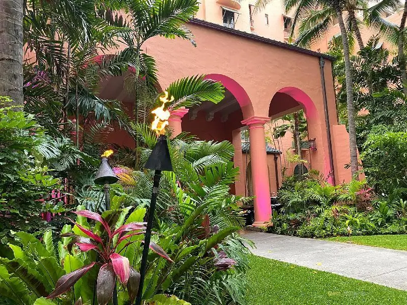 Royal Hawaiian Hotel tropical garden with tiki torches.