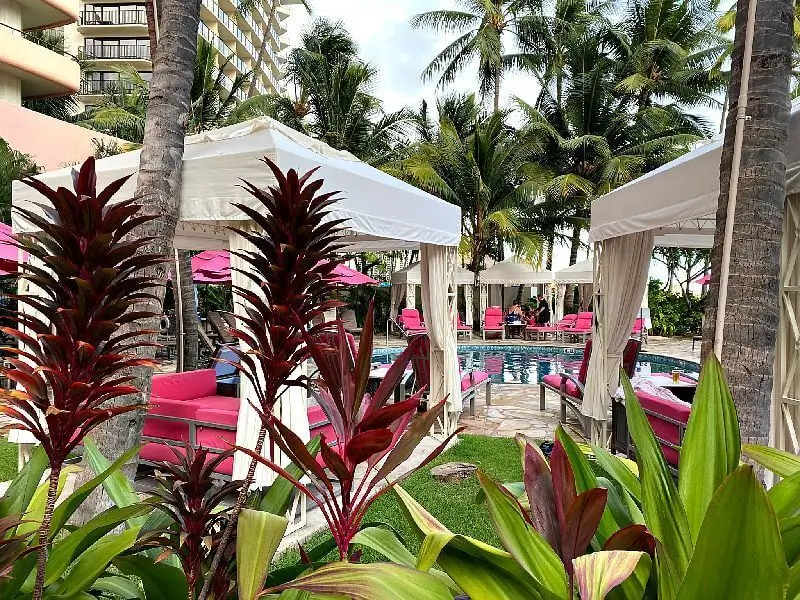 Royal Hawaiian Malulani Pool, surrounded by tropical gardens and poolside cabanas.