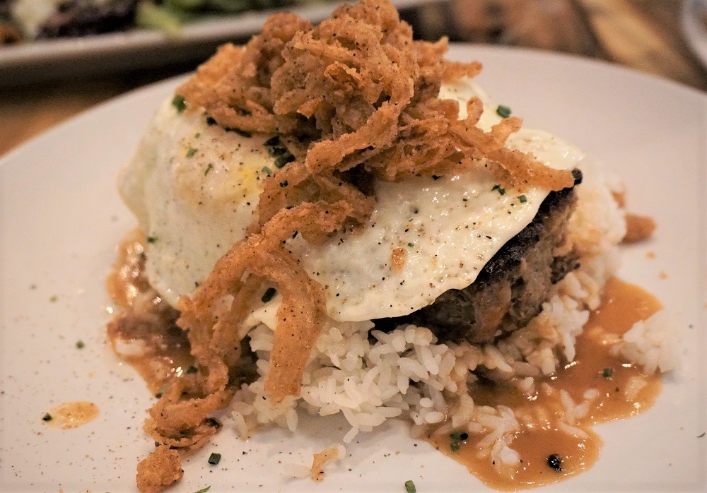 The Surfing Pig The Surfing Pig is a trendy and casual eatery that serves mouthwatering dishes inspired by Hawaiian and global flavors, combining the best of comfort food with a touch of culinary innovation.