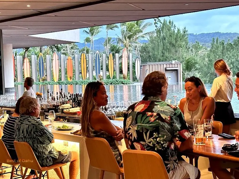 Turtle Bay Resort open air Off The Lip Bar Turtle Bay Resort open air Off The Lip Bar that overlooks a colorful line of surfboards that line a walkway down to the pool area.