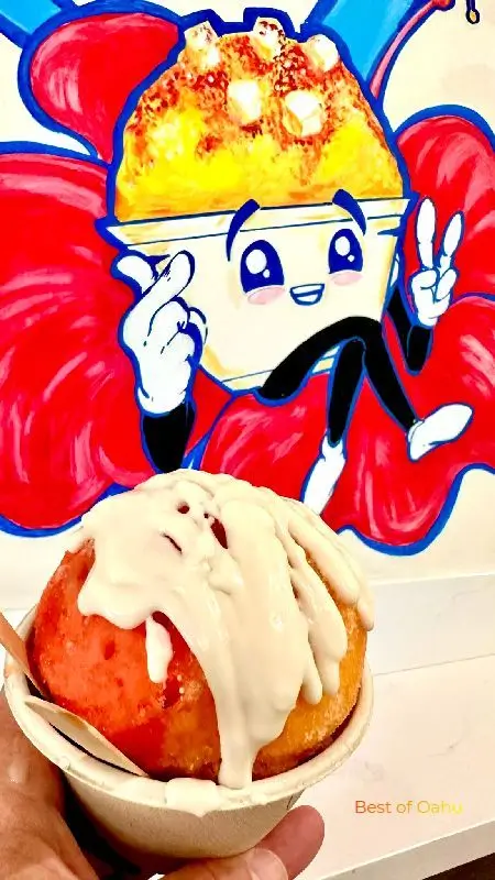 Ululanis Hawaiian Shave Ice Ululanis Hawaiian Shave Ice Mural and featured bowl of shave ice with tropical flavors and haupia cream on top.