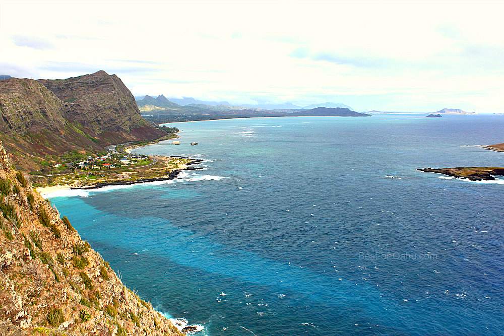 A scenic view of Oahu's Windward Coast, showcasing pristine beaches, lush green mountains, and the sparkling turquoise waters of the Pacific Ocean, offering a peaceful and picturesque escape from the bustling city life.
